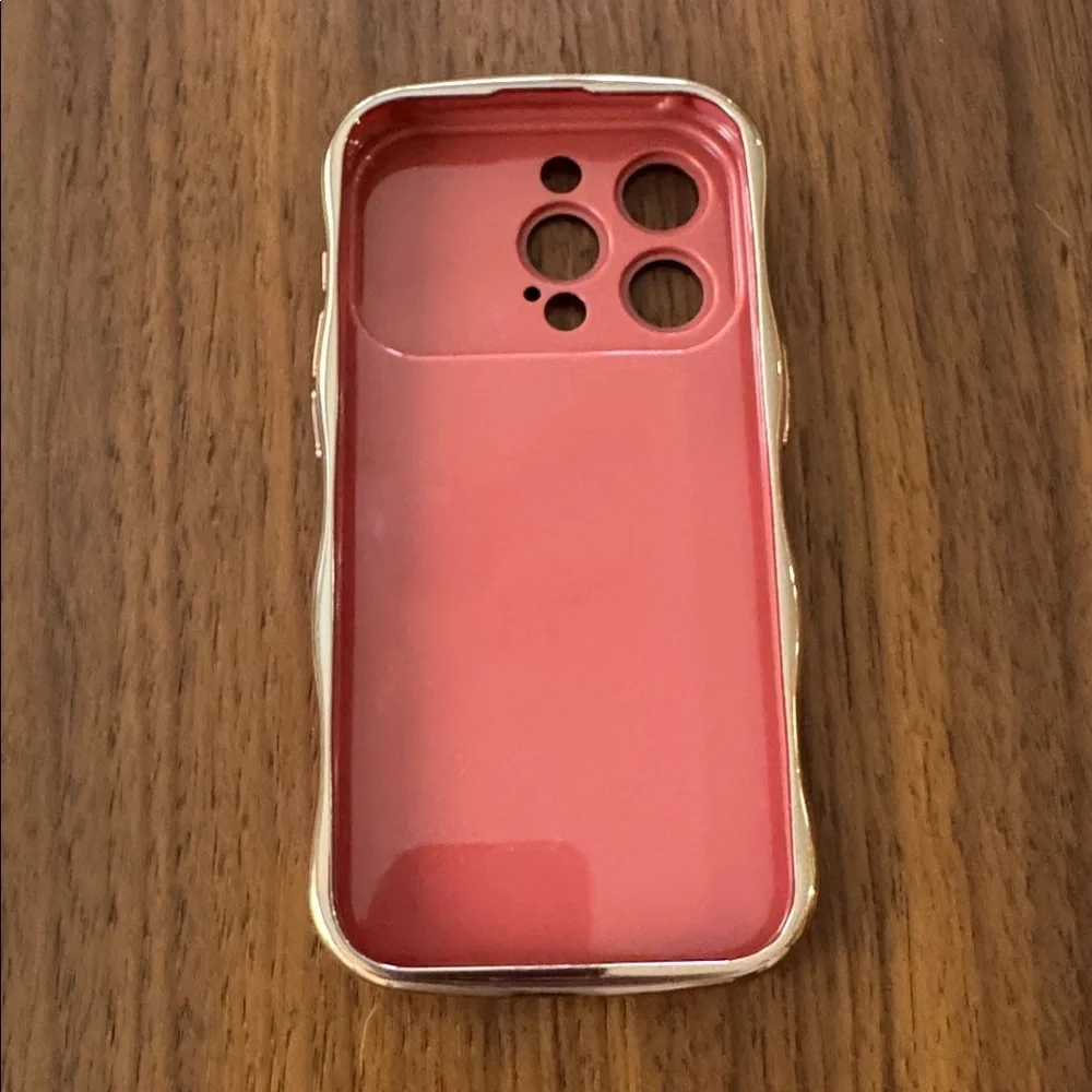 NWOT Faint Red Wave Phone Case for 15 Pro with Gold Trim.